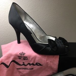 Nina black satin formal peep toe shies with delicate bow detail.